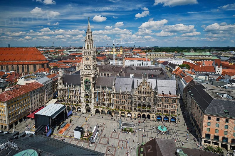 Elevated perspective of the gothic Neues Rathaus and the bustling Marienplatz square on a sunny afternoon in Munich, Bavaria, Germany