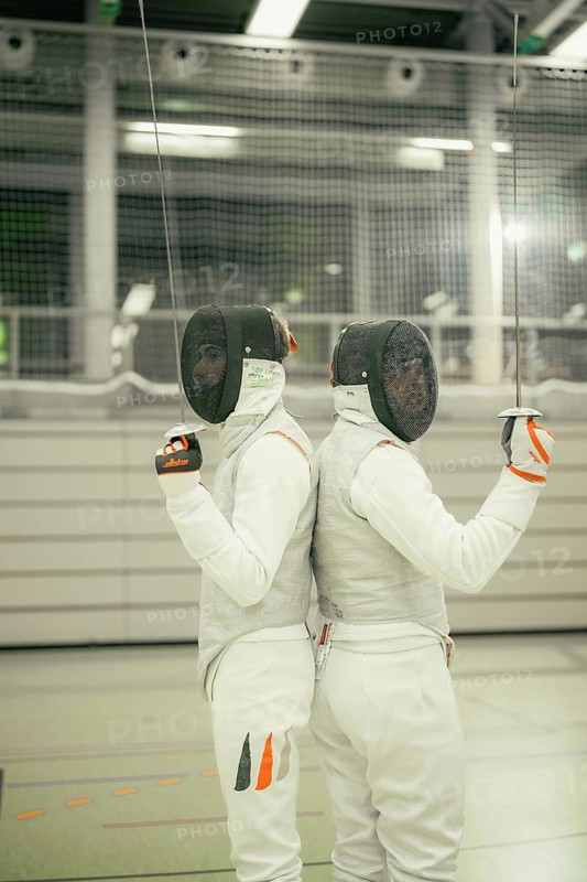 Two fencers in full armor positioning themselves back to back in a hall, fencing, TSV Calw, Calw district, Germany