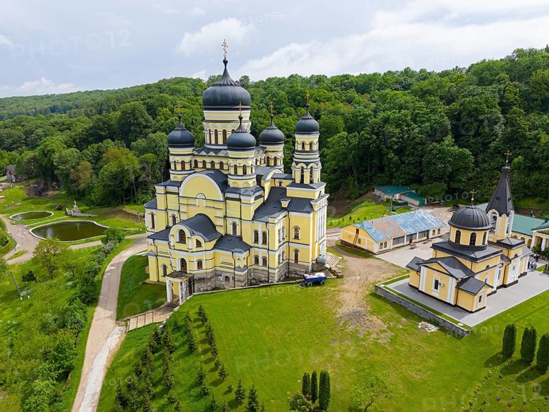 Orthodox monastery with yellow paint and domes surrounded by green landscape, aerial view, Hîncu monastery, Hâncu, Hâncul, Hincu, Hancu, Hancul, located near the village of Bursuc, Nisporeni district, Republic of Moldova, Moldova