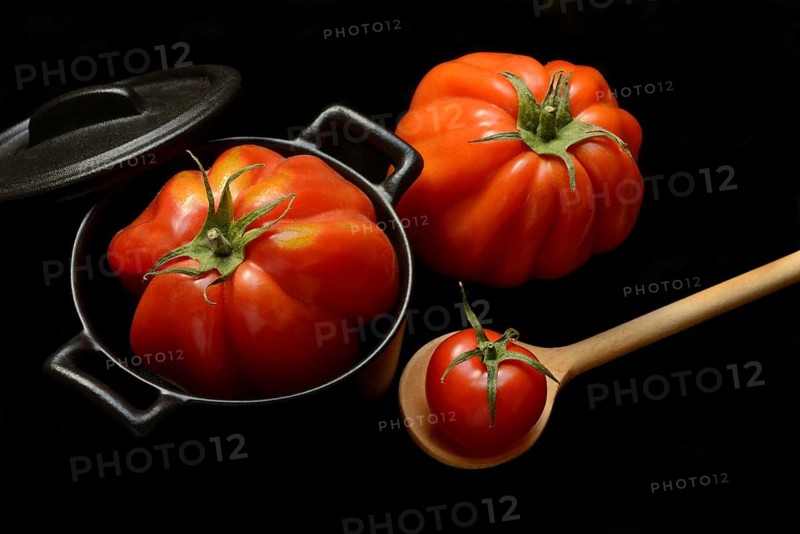 Tomatoes in pots and cooking spoon, Solanum lycopersicum