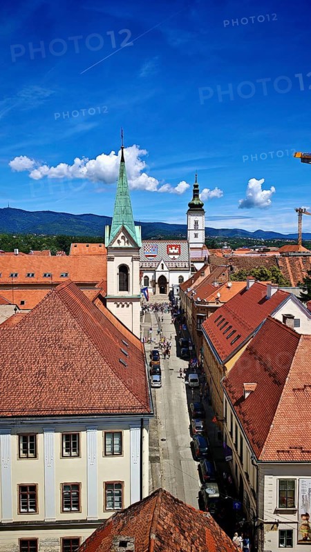 View from Lotrscak Tower, panoramic view of a city with red roofs, a church tower and a clear blue sky, Zagreb, Croatia