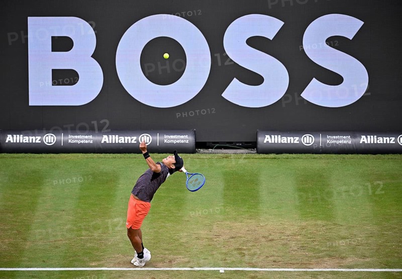 Rinky Hijikata (AUS) in action serving, with a Boss logo on the backboard, BOSS Open 2026, ATP 250 tennis, grass-court tournament, Stuttgart, Baden-Württemberg, Germany