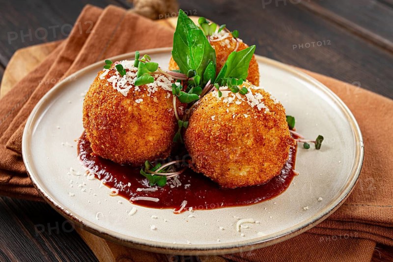 Crispy Arancini appetizer, with parmesan cheese and microgreens, plate, tomato sauce, homemade, no people