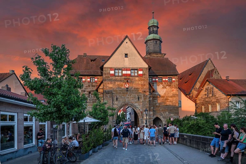 City festival goers walk through the historic Nuremberg Gate, evening sky, Lauf an der Pegnitz, Middle Franconia, Bavaria, Germany