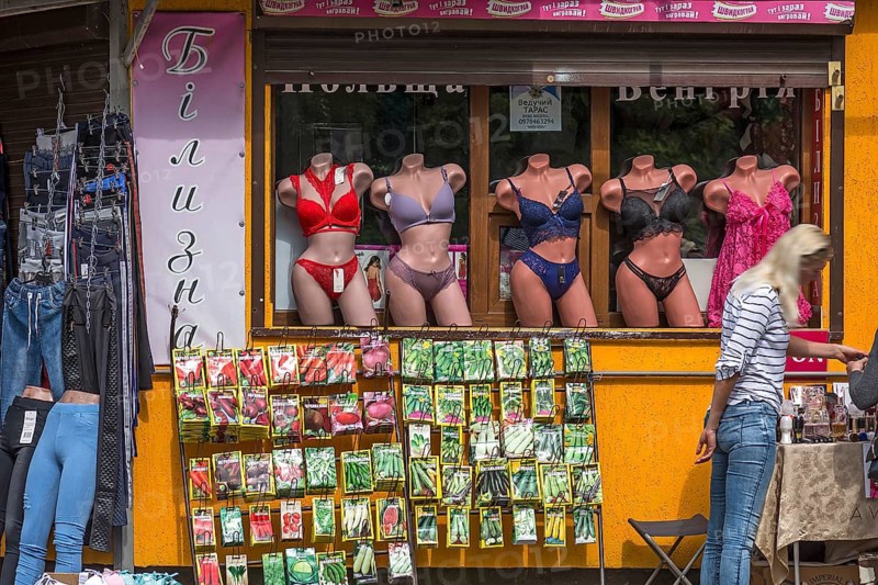 Window mannequins with lingerie, bottom offering rack with vegetable seed bags, Lviv, Ukraine