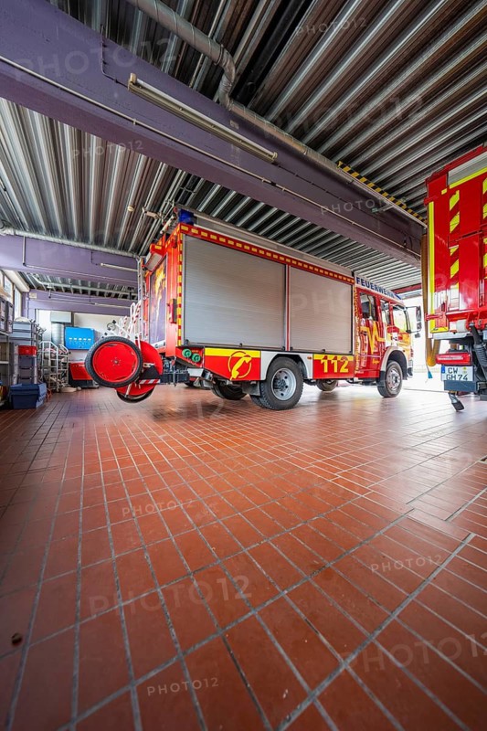 Interior of a fire department garage with several red vehicles and industrial equipment, Gechingen fire department, Calw district, Germany