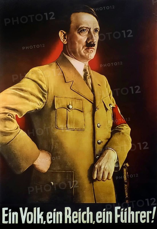 German vintage World War Two Nazi propaganda poster showing Adolf Hitler posing in brown military uniform and wearing red Nazi swastika armband