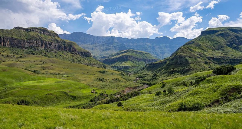 Mountainous landscape of the Cathedral Range mountains and green mountain valley, Drakensberg Mountains, KwaZulu-Natal, South Africa