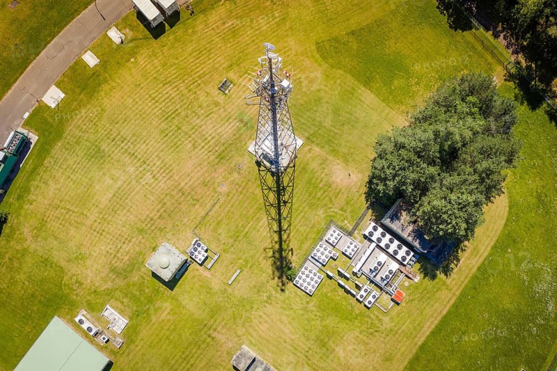 A radio tower in the middle of a green area with technology facilities, bunker plant, Calw, Germany