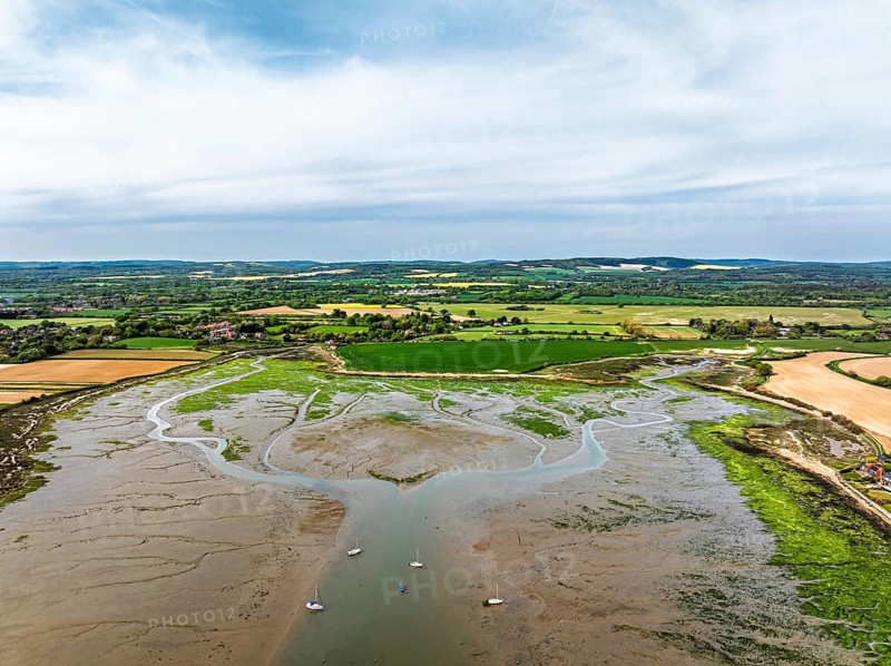 Fields and Farms over Bosham Quay from a drone, Chichester Harbour National Landscape, Chichester, West Sussex, England, United Kingdom
