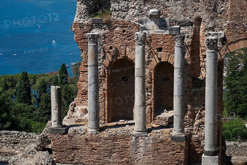 View of ancient theatre pillars and the Mediterranean Sea, Taormina, Sicily, Italy