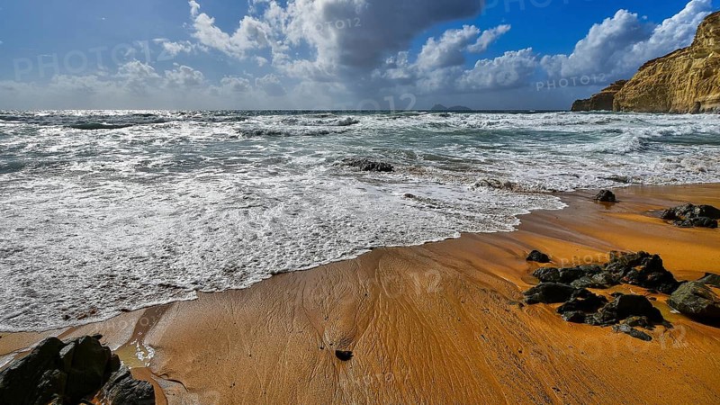 Red Beach, a dream beach in the neighboring bay of Matala, wild waves meet a sandy beach with rocks under a dramatic sky, Matala, south coast, Crete, Greek Islands, Greece