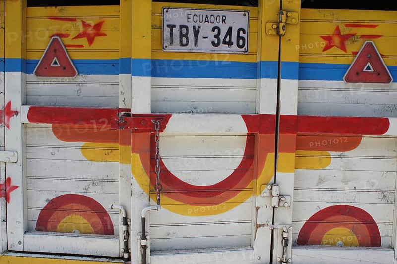Close-up of a colorfully painted truck door, with Ecuadorian license plate and geometric patterns, Ecuador