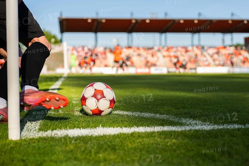 Close-up of a player's feet and a soccer ball at the corner arc, ready to perform a corner kick in Glogow, Poland