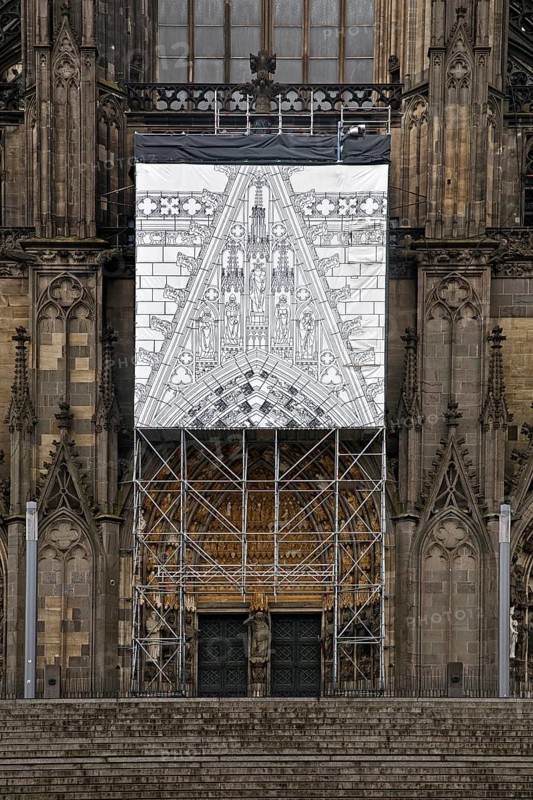 Scaffolding with black and white depiction of the restoration work on the north façade, Cologne, Rhineland, North Rhine-Westphalia, Germany