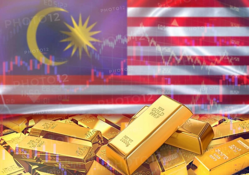Gold bars on Malaysian flag in background. Gold bars stacked on Malaysian flag. Concept of Malaysia gold reserves