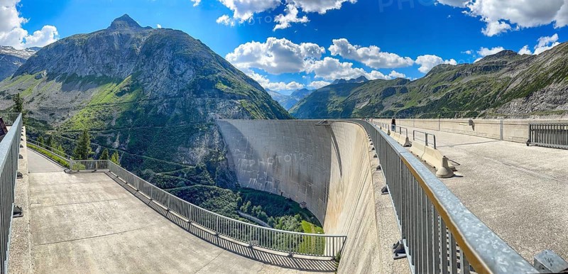 View of left footpath and roadway for company vehicles on 200 meter high Kölnbrein dam left air side facing away from the water with Airwalk viewing platform in the background, Malta Valley, Carinthia, Austria