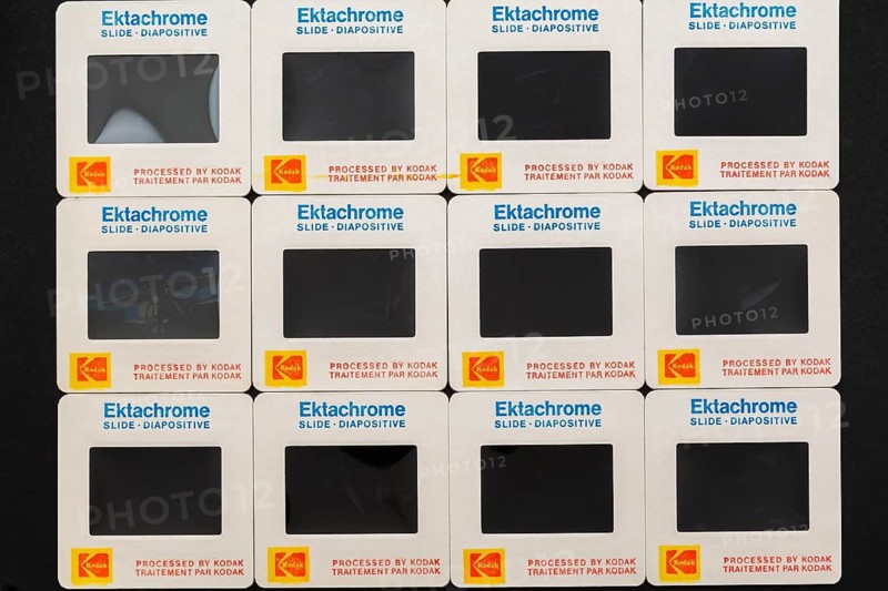 Rows of old neatly arranged Kodak Ektachrome 1980s 35mm slides mounted in white cardboard frames with bilingual English and French wording for the Canadian market, Studio Composition, Quebec, Canada