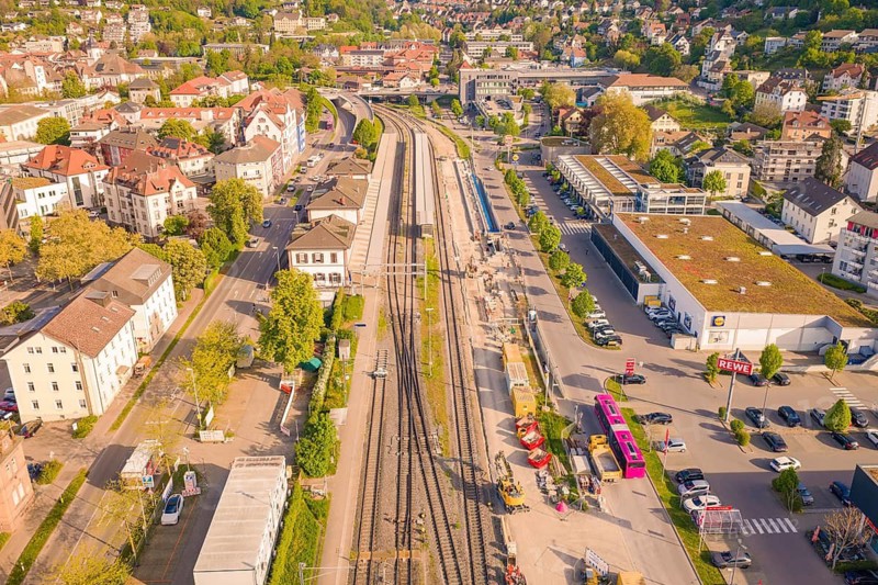 Urban station district with tracks, surrounding buildings and parked buses in summer, electrification of the High Rhine Railway, conversion of the train station, Waldshut, Tiengen, Germany
