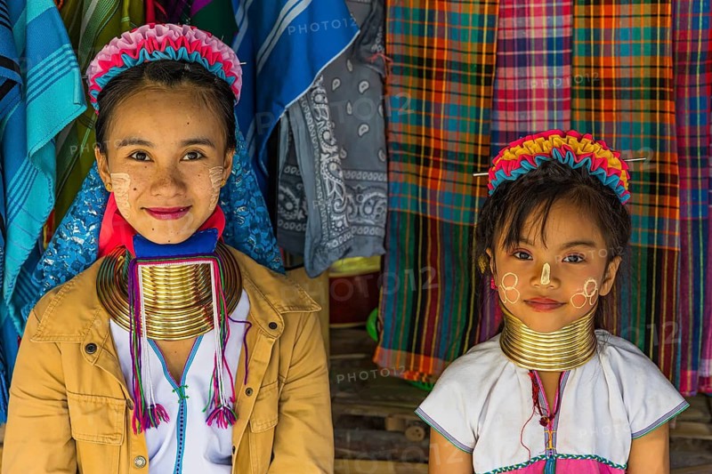 Children from the Karen minority group wearing brass rings around their necks, colorful traditional head covering and clothing, Karen Long Neck Village, Chiang Mai, Thailand