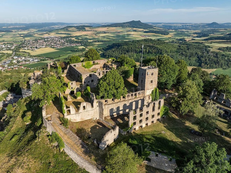 Aerial view of the Hohentwiel volcanic cone with Germany's largest fortress ruin, in the morning sun, on the Hohenstoffeln horizon, Hohenhewen on the right, Hegau, district of Konstanz, Baden-Württemberg, Germany