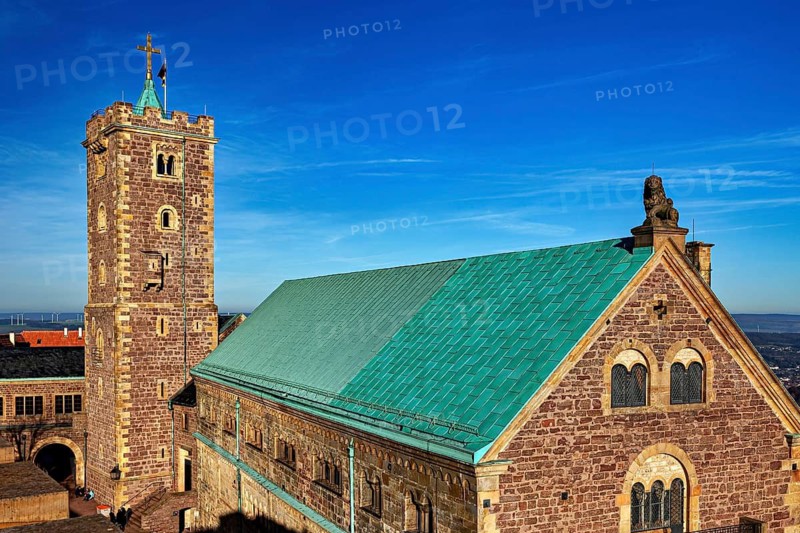 Castle on a hill with a distinctive tower and green roof, blue sky, The Wartburg near Eisenach in Thuringia