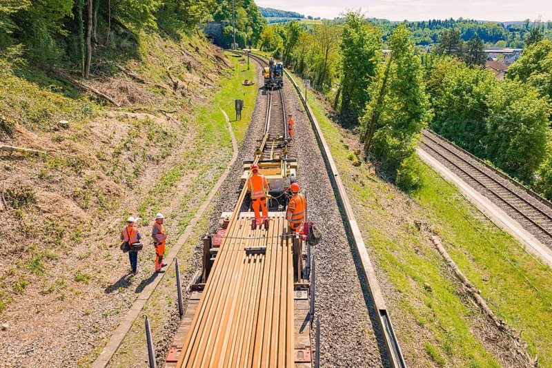 Worker on a rail train in a rural area with surrounding green hills, electrification of the Hochrheinbahn, conversion of the railway station, Waldshut, Tiengen, Germany