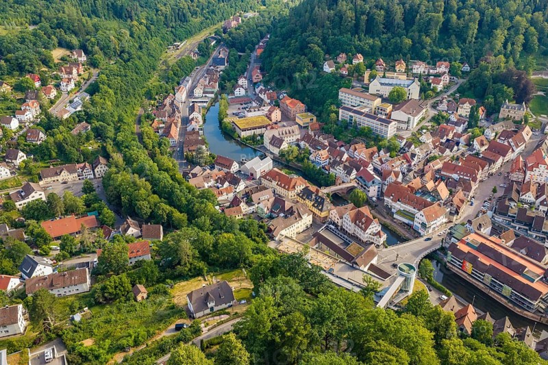 A summer landscape with a city, hills and a river from the air, Hermann Hesse Railway, Calw, Germany