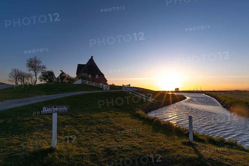 Kirchwarft with pastor and church on Hallig Hooge in the Schleswig-Holstein Wadden Sea National Park, Halligen biosphere, evening mood, priel, wooden fence, name tag, trees, salt marshes, North Frisia, backlight view, Schleswig-Holstein, Germany