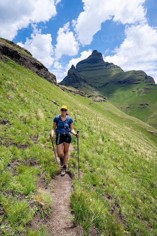 Female hiker on the hiking trail to Cathedral Peak, Green Mountains and Hills, Drakensberg Mountains, KwaZulu-Natal, South Africa