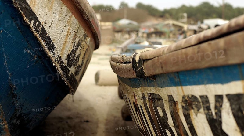 Close-up, Two traditional wooden boats side by side in the sand of a fishing village, Cap Skirring, Casamance, Senegal