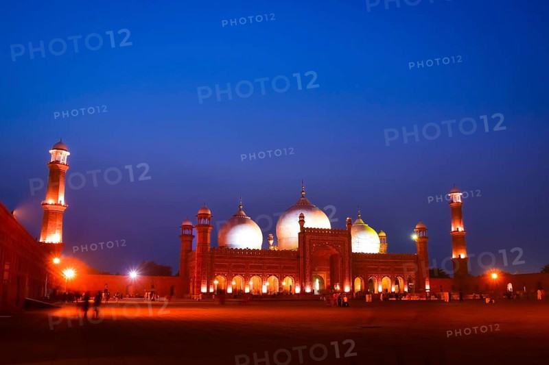 Lahore, Pakistan - 24th october, 2024: Badshahi mosque Lahore timelapse zoom in day to night transition glowing domes minarets courtyard lights historic mughal architecture pakistan landmark twilight