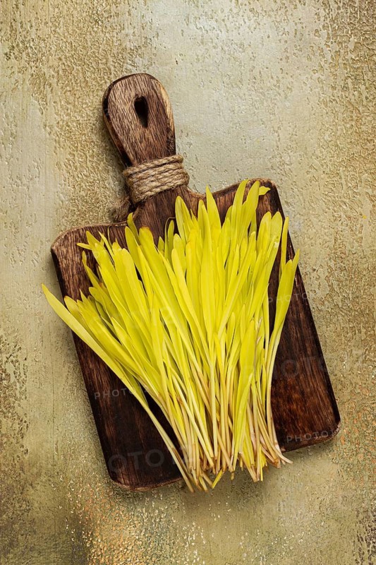A microgrown corn, a bouquet on a cutting wooden board, no people