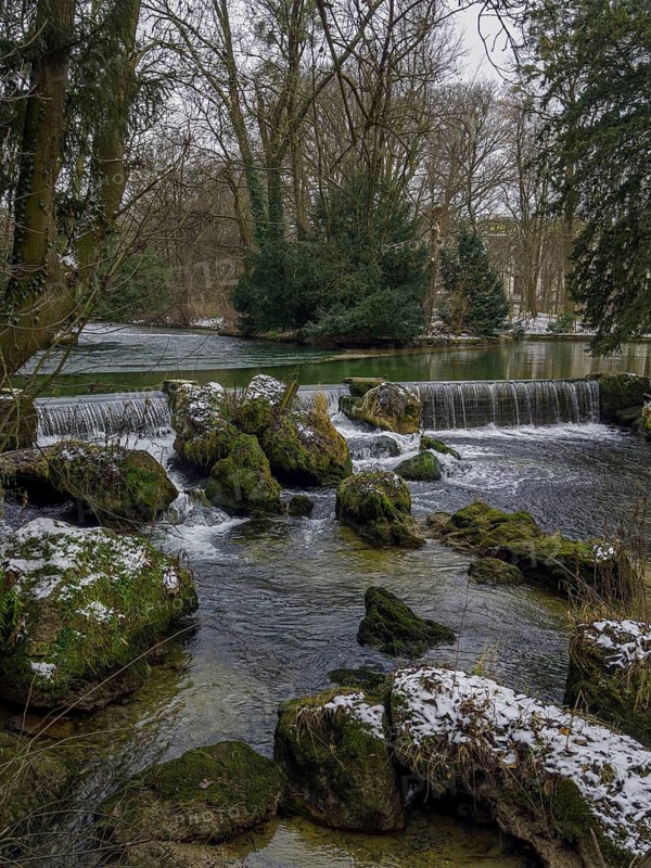 Small waterfall, winter in the English Garden, Munich, Bavaria, Germany