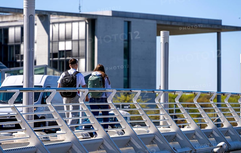 Pedestrians and cyclists on Kronzprinzenbrücke, Regierungsviertel Berlin, Germany
