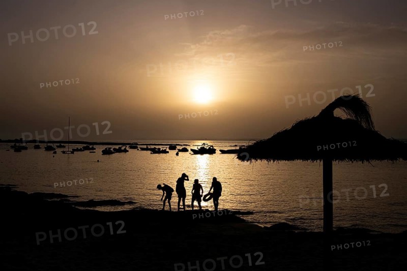 The sun sets on the horizon over the sea on the Spanish Balearic island of Majorca, Colonia de Sant Jordi, Majorca, Spain