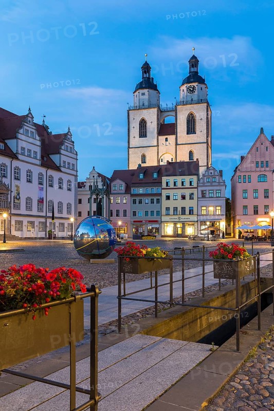 Atmospheric night view of market square with city church and old town hall, Luther city Wittenberg, Saxony-Anhalt, Germany