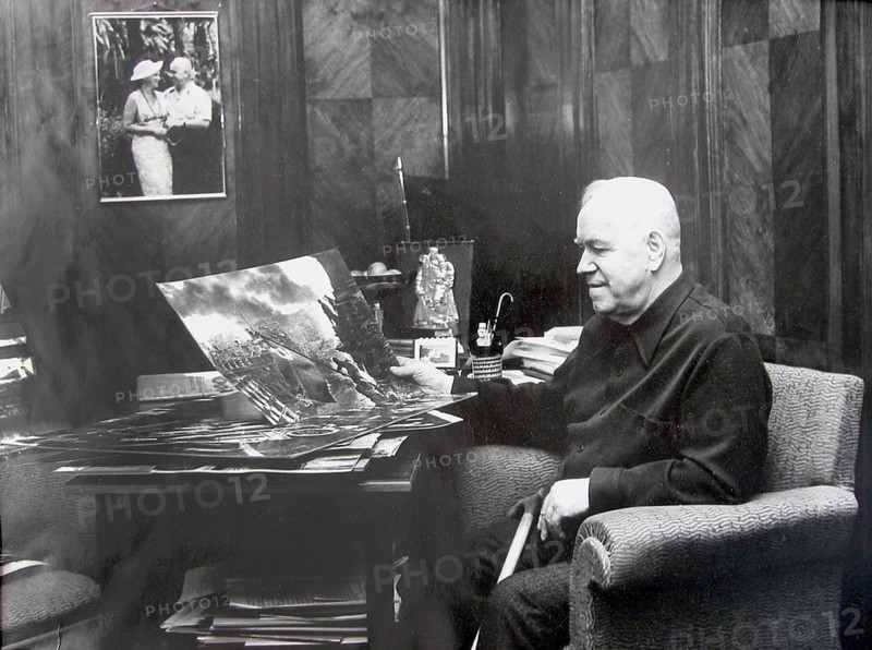 Marshal Zhukov looks at the most famous image and symbol of the victory over Natidonal Socialism by J. Chaldej. The flag raising at the Berlin Reichstag on May 2, 1945. Office of Marshal Zhukov, Moscow, 1972 J. Chaldej about this photo: 'In 1972, Adjutant Marshal Zhukov called me and said: 'Yevgeny Ananyevich, Marshal Zhukov would like to talk to you. 'I thought maybe someone was joking with me? Then the receiver cracked and a voice said, “Hello, Yevgeny Ananyevich, this is Zhukov.” I said, “Hello Georgi Konstantinovich, what can I do for you? “I have a request for you: I have a photo of you riding the white horse across Red Square at the Victory Parade. Could you enlarge that for me? ' “Good, ” I said: “I'll make a 100 x 120 centimeter deduction.” “I'll send a car to pick you up and the photo.” I say, “Can I bring photos I took during the war?” “Yes, ” he said, “I