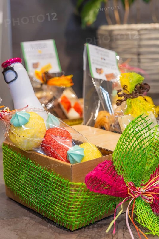 A colorful gift basket with chocolates, lovingly decorated and packaged, conveys a cheerful and festive atmosphere, gift basket
