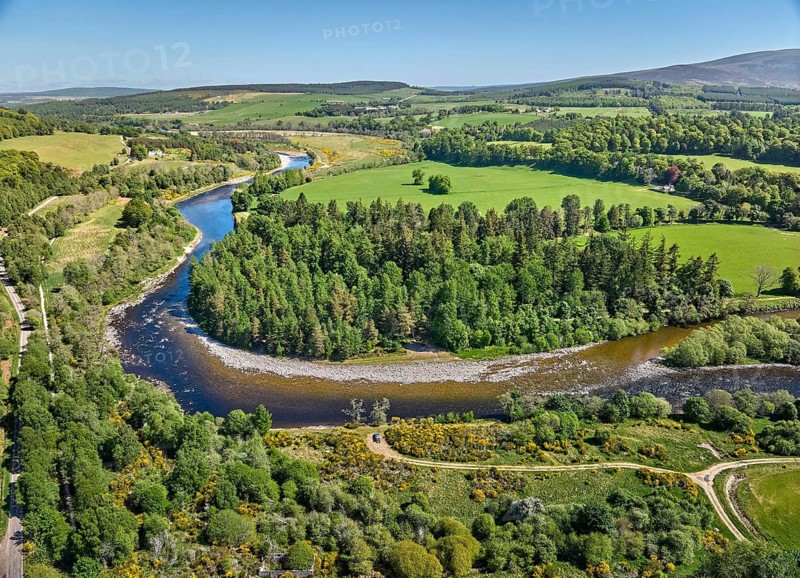 Aerial drone view of the forest and pasture landscape at Spey River in eastern Scotland, UK
