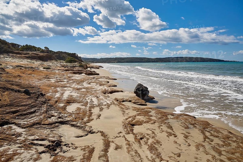 Vulcanic Beach, A secluded beach with blue sea and white clouds in the sky, Kos, Dodecanese, Greek Islands, Greece