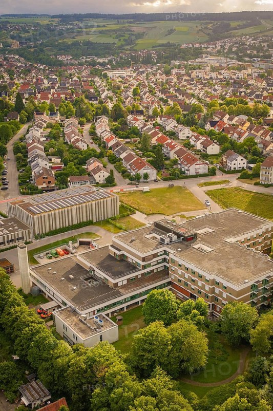 Bird's-eye view of a city with numerous houses and a large building in green surroundings, new IGZ, Herrenberg Integrated Health Center, former Herrenberg Hospital, Böblingen district, Germany
