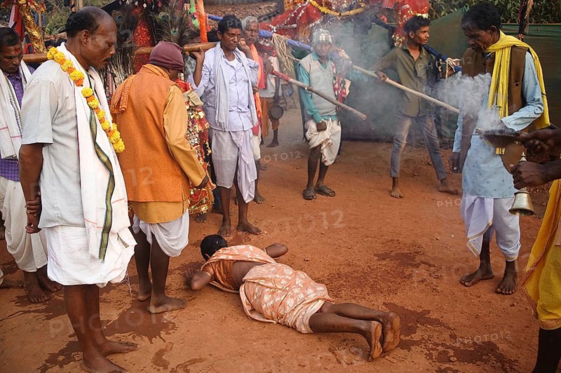 Madai festival in Bastar region (Chhattisgarh, India), Madai is a popular festival followed by the Gond tribe. The festival is spanning months. This is a celebration where gods (ancestral and guardians deities) leave their shrines to visit one another, and tribals gather to worship their deities. On this photo, a woman is bowing down before a local deity