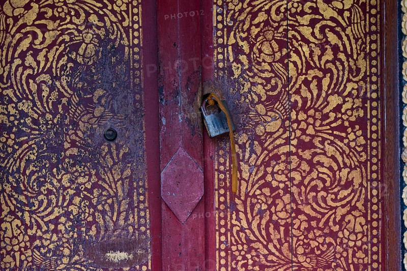 Artfully painted door with old castle, Buddhist temple, monastery, Wat May Souvannapoumaram, Luang Prabang, Laos, Southeast Asia