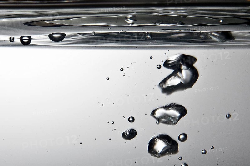 Air bubbles rise to the water surface