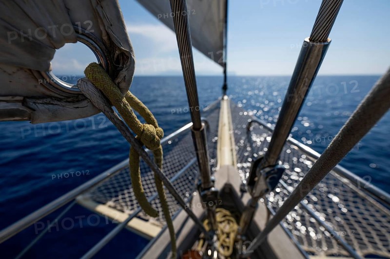 Looking forward from a sailboat, over deep blue water with light waves, Aeolian or Aeolian Islands, Sicily, Southern Italy, Italy