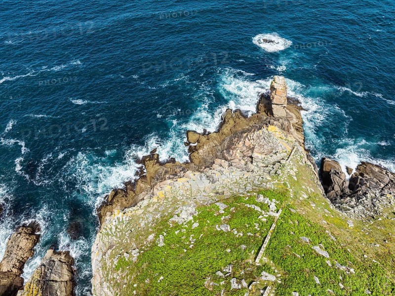 Aerial view, top down view of steep granite rocks at Pointe du Raz on the stormy Breton coast, at whose edges the ocean spray breaks white, Plogoff, Cap Sizun, Finistère department, Brittany region, France