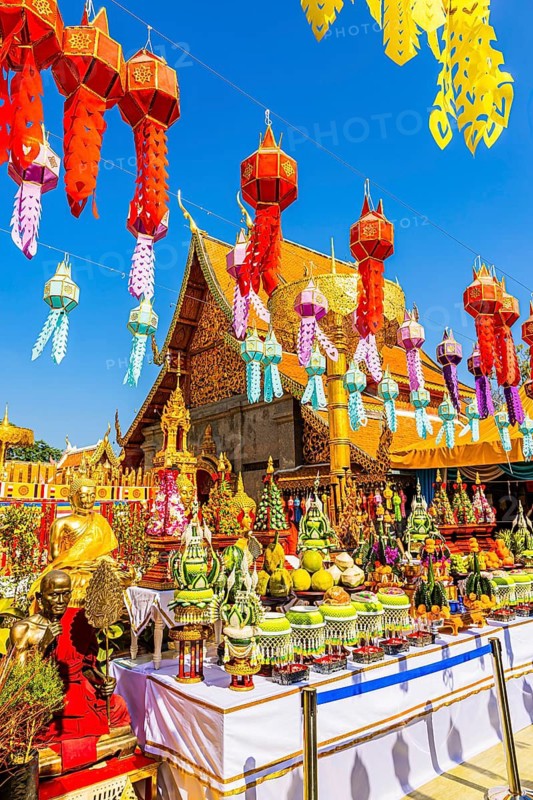 Sacrificial table with offerings and colorful lanterns lined up in the Wat Phra That Doi Suthep temple complex, Chiang Mai, Thailand