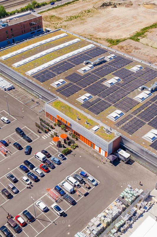 Building with solar systems on the roof and parking lot from an aerial perspective, PV system at OBI Baumarkt, Mühlacker, Enzkreis, Germany