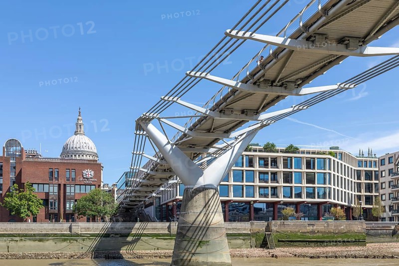View under Millennium Bridge footbridge to dome of St Pauls cathedral, north bank of River Thames, London, England, UK